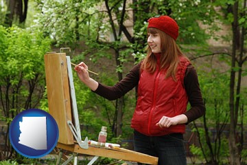 a female plein air artist painting with oils on a portable easel - with Arizona icon