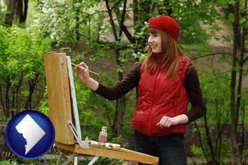 a female plein air artist painting with oils on a portable easel - with Washington, DC icon