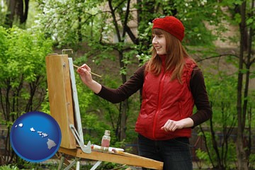 a female plein air artist painting with oils on a portable easel - with Hawaii icon