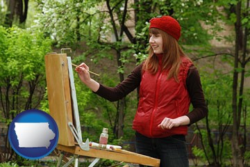 a female plein air artist painting with oils on a portable easel - with Iowa icon