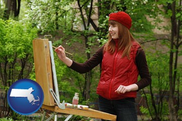 a female plein air artist painting with oils on a portable easel - with Massachusetts icon