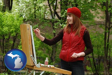 a female plein air artist painting with oils on a portable easel - with Michigan icon