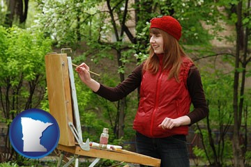 a female plein air artist painting with oils on a portable easel - with Minnesota icon