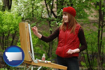 a female plein air artist painting with oils on a portable easel - with Montana icon