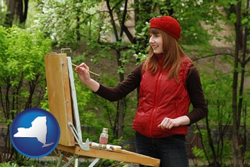 a female plein air artist painting with oils on a portable easel - with New York icon